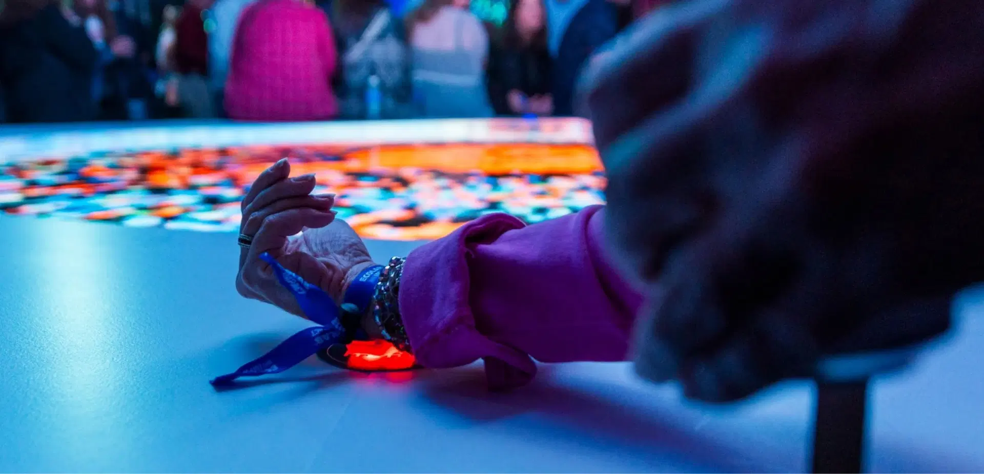 Attendee using NFC wristband at CrowdPass-powered event activation